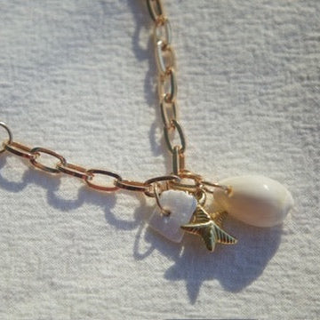 Handmade gold layering necklace with mixed cable and oval link chain and coastal charm cluster"